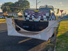 Truck with a checkered design and flag on the back, parked on a street with the Mammoth Mount and Haven Safari displayed.
